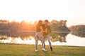 Romantic, social dance and people concept - young couple dancing bachata on the background of sunset Royalty Free Stock Photo