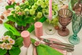 Romantic spring table setting for two with wine glasses, candles and flowers Royalty Free Stock Photo