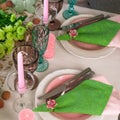 Romantic spring table setting for two with wine glasses, candles and flowers Royalty Free Stock Photo