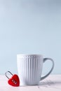Blue Cup With Hot Drink Andred Lock In Form Of Heart On White Marble Background
