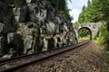 Romantic stone bridge over railway in beautiful forest, Czech republic