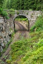 Romantic stone bridge over railway in beautiful forest, Czech republic