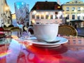 Romantic   street cafe Tallinn.Estonia Old town square . evening street cafe  ,cup of coffee on table top ,blue glass of wine , Royalty Free Stock Photo