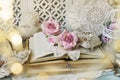 Romantic style arrangement with old books and roses on the table