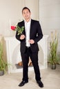 Romantic suitor carrying a red rose