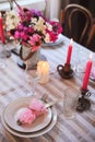Romantic summer dinner in cozy country house. Festive table setting with flowers and candles Royalty Free Stock Photo