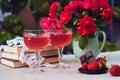 Romantic summer table settings. Couple glasses of red strawberry wine. Natural strawberry infusion. Strawberry and Royalty Free Stock Photo