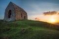 Romantic sunset on Cornish coast with lonelly chapel on cliff. Royalty Free Stock Photo