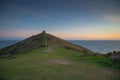 Romantic sunset on Cornish coast with lonelly chapel on cliff. Royalty Free Stock Photo