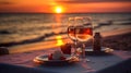 Romantic sunset dinner on the beach. Table honeymoon set for two with luxurious food, glasses of rose wine drinks in a restaurant Royalty Free Stock Photo