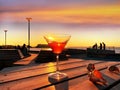 Romantic sunset at pier  glass of orange juice  on wooden table and seashell  in beach cafe   . people  silhouette walk and  relax Royalty Free Stock Photo