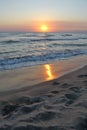 Romantic sunset reflected on the beach, vertical