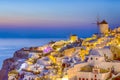 Romantic Sunset at Santorini Island in Greece. Image Taken in Oia Village At Dusk. Amazing Sunset with White Houses and Windmills Royalty Free Stock Photo