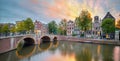 Romantic sunset in Amsterdam. Panoramic views of the old houses, the bridge and the canal. Amsterdam, Holland, Netherlands, Europe Royalty Free Stock Photo