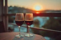 Romantic sunset with two glasses of red wine on balcony Royalty Free Stock Photo