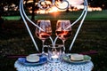 romantic sunset with two glasses of red wine, two pieces of cheesecake, a tealight Royalty Free Stock Photo