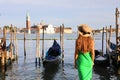 Romantic sunset in Venice, Italy. Back view of young woman admiring Venetian Lagoon