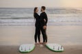 Romantic Surfers Couple Having Date On The Beach, Embracing And Smiling Royalty Free Stock Photo