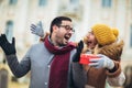 Romantic surprise for Christmas. Couple with present outdoor Royalty Free Stock Photo