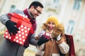 Romantic surprise for Christmas. Couple with present outdoor Royalty Free Stock Photo