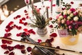 Romantic table setting with beautiful flowers in box, rose petals and violin Royalty Free Stock Photo