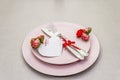 Romantic table setting on light stone concrete background. Valentine`s day or Wedding card template. Paper heart, flowers, cutler Royalty Free Stock Photo