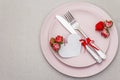 Romantic table setting on light stone concrete background. Valentine`s day or Wedding card template. Paper heart, flowers, cutler Royalty Free Stock Photo