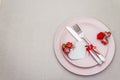 Romantic table setting on light stone concrete background. Valentine`s day or Wedding card template. Paper heart, flowers, cutler Royalty Free Stock Photo