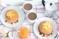 Breakfast for two. American pancakes with orange jam and nuts on vintage plates and 2 white coffee cups. Top view Royalty Free Stock Photo