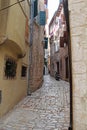 Romantic travel location, picturesque paved old narrow stone street in the Old Town of Rovinj, Croatia. Europe Royalty Free Stock Photo
