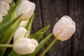 Romantic tulip bouquet on wooden background