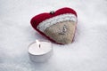 Romantic Valentine Plush Heart With A Winged Metal Heart On Ice Besides A Peaceful Tealight