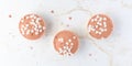 Romantic Valentine\'s or birthday cupcakes covered glaze in trendy color 2024 Peach Fuzz with heart shape sprinkles