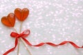 Romantic Valentine`s day background. Lollipops in the shape of heart close up on white background.