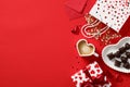 Romantic Valentine`s Day concept. Top view Love letter, heart-shaped coffee cup, candies, and gift box on red background Royalty Free Stock Photo