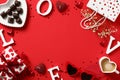 Romantic Valentine`s Day frame with heart-shaped candy, gift box, candles, coffee mug and other festive decorations Royalty Free Stock Photo