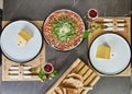 Romantic Valentine's Day dinner table setting for two with a greeting card and mouthwatering carpaccio made with