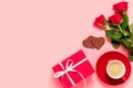 Romantic Valentine's day flat lay with copy space for text. Red roses, gift bos, chocolate hearts and cup of coffee on Royalty Free Stock Photo