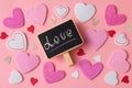 Romantic Valentines day background. A large number of hearts of different size with little blackboard and word love on Royalty Free Stock Photo