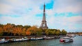 Romantic view in Autumn season with Eiffel Tower and boats on Seine river in Paris, France