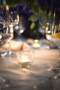 Glass with candles lit inside , on a table