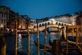 Romantic view of the Rialto Bridge in Venice at night. In the foreground some typical gondolas. Royalty Free Stock Photo