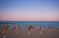 Romantic view of sea with umbrellas at dusk