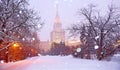 Romantic view of snowfall in white winter campus of famous Russian university with snowed evergreen trees