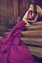 Romantic Vintage Woman Fashion. Victorian Lady relax Outside on wooden Steps. 19th Century Female Historical Dress Costume Royalty Free Stock Photo