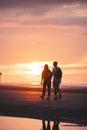 Romantic walk of a young couple on the beaches of Oostende in western Belgium at sunset. Love and devotion. Reflection in a pool Royalty Free Stock Photo