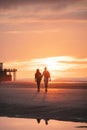 Romantic walk of a young couple on the beaches of Oostende in western Belgium at sunset. Love and devotion. Reflection in a pool Royalty Free Stock Photo