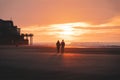 Romantic walk of a young couple on the beaches of Oostende in western Belgium at sunset. Love and devotion. Reflection in a pool Royalty Free Stock Photo