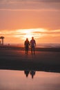 Romantic walk of a young couple on the beaches of Oostende in western Belgium at sunset. Love and devotion. Reflection in a pool Royalty Free Stock Photo