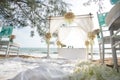 Romantic wedding ceremony on the beach under the pines. Royalty Free Stock Photo